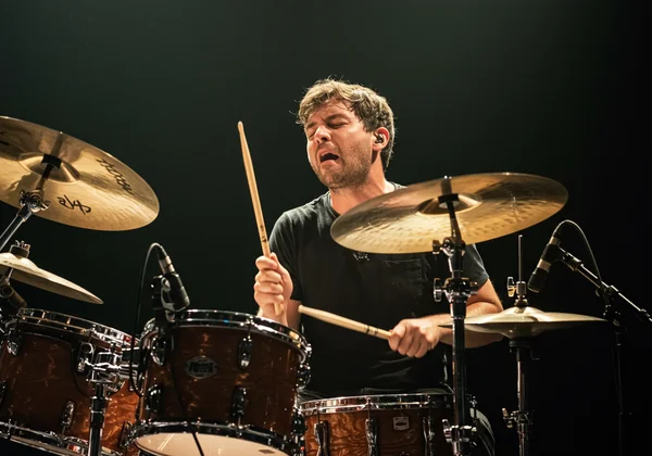 A drummer playing, demonstrating rhythmic independence.
