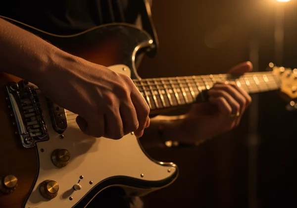 Close-up of a musician's hands playing a funk groove.